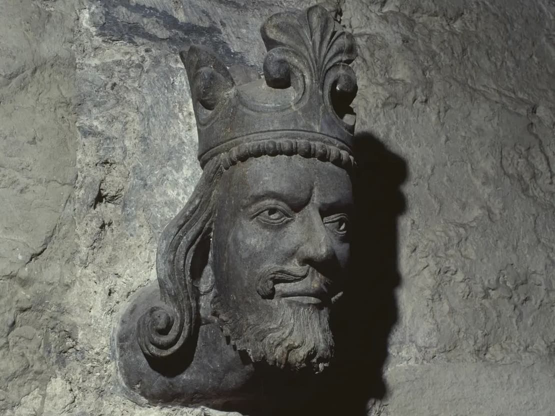 Sculpted royal head over a church door.