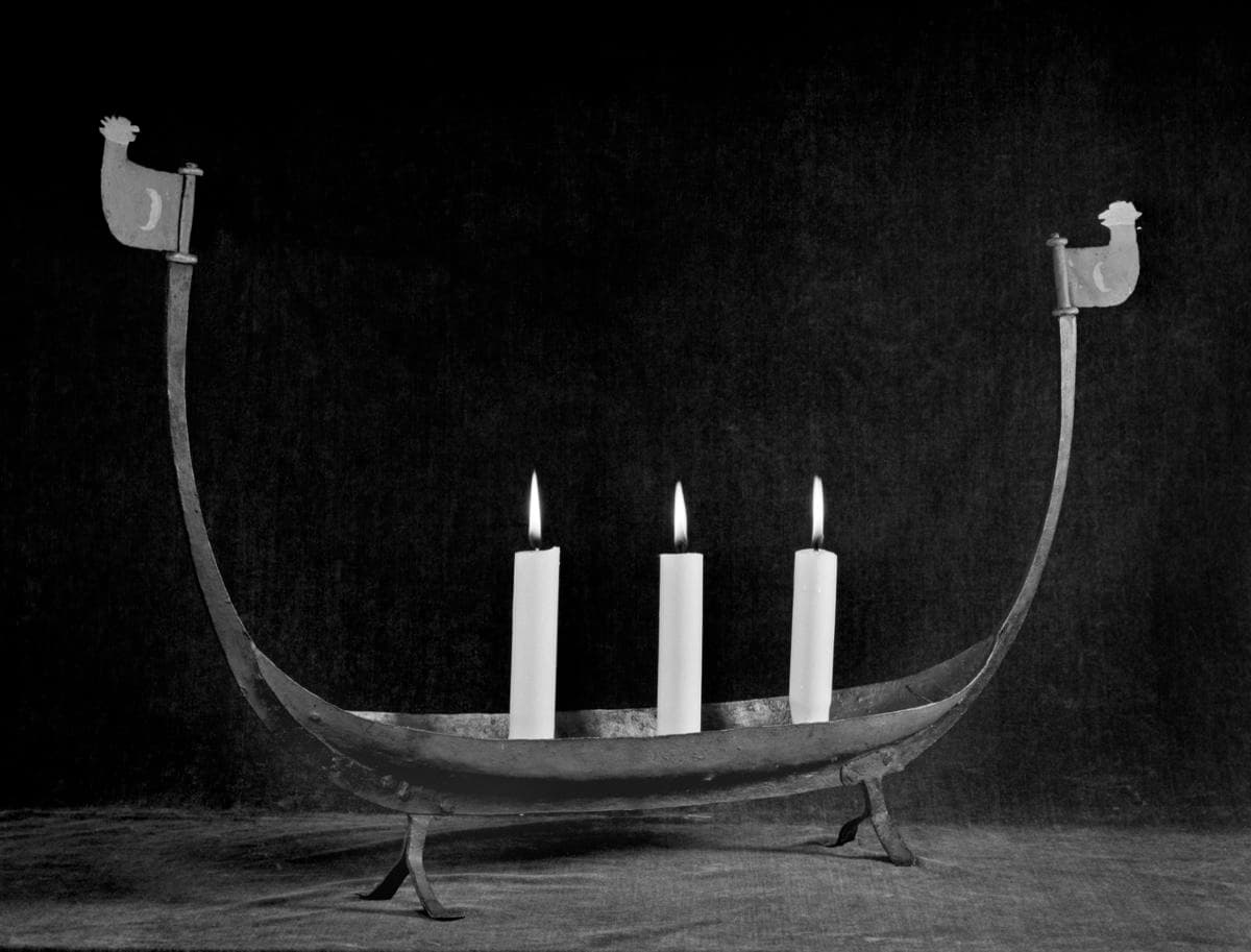 Iron candlestick shaped like a longship.